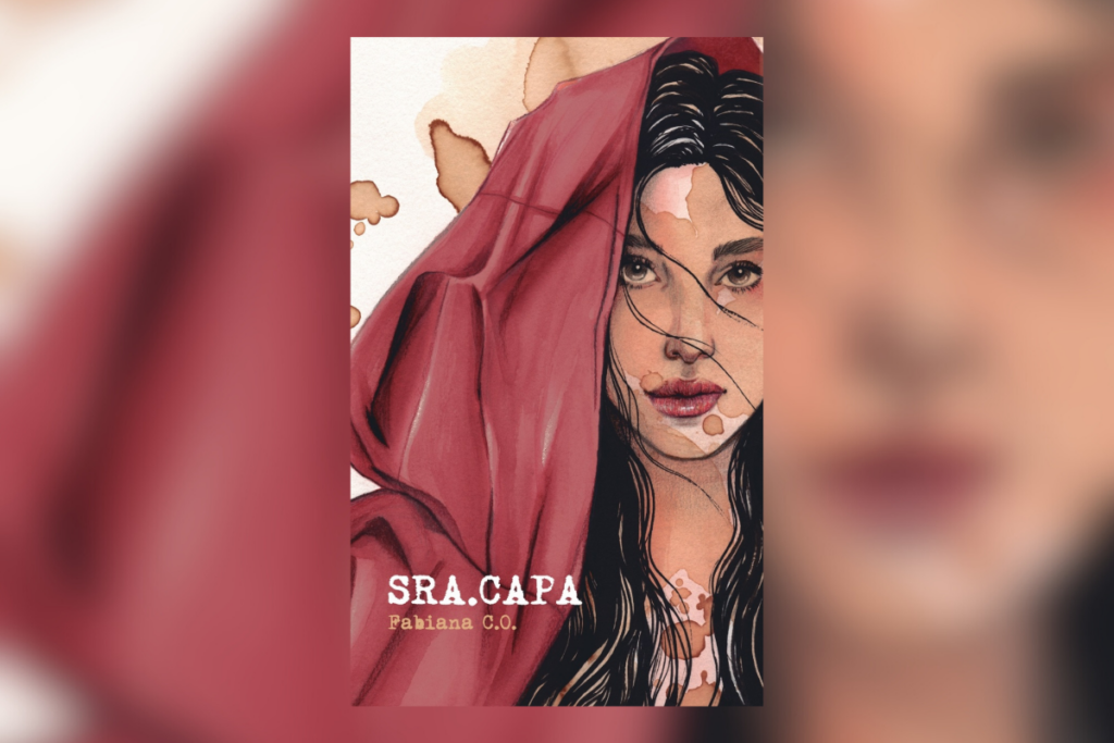 Capa de livro com a imagem de uma mulher usando uma capa vermelha e o título e nome da autora 