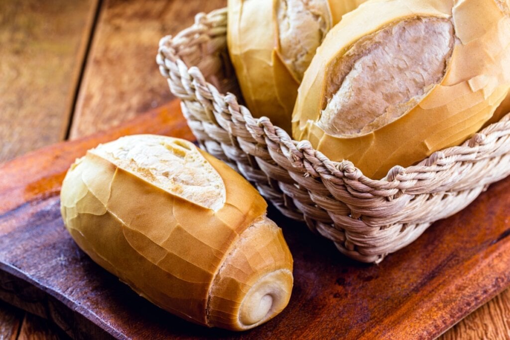 pão francês ao lado de cesto com outros pães