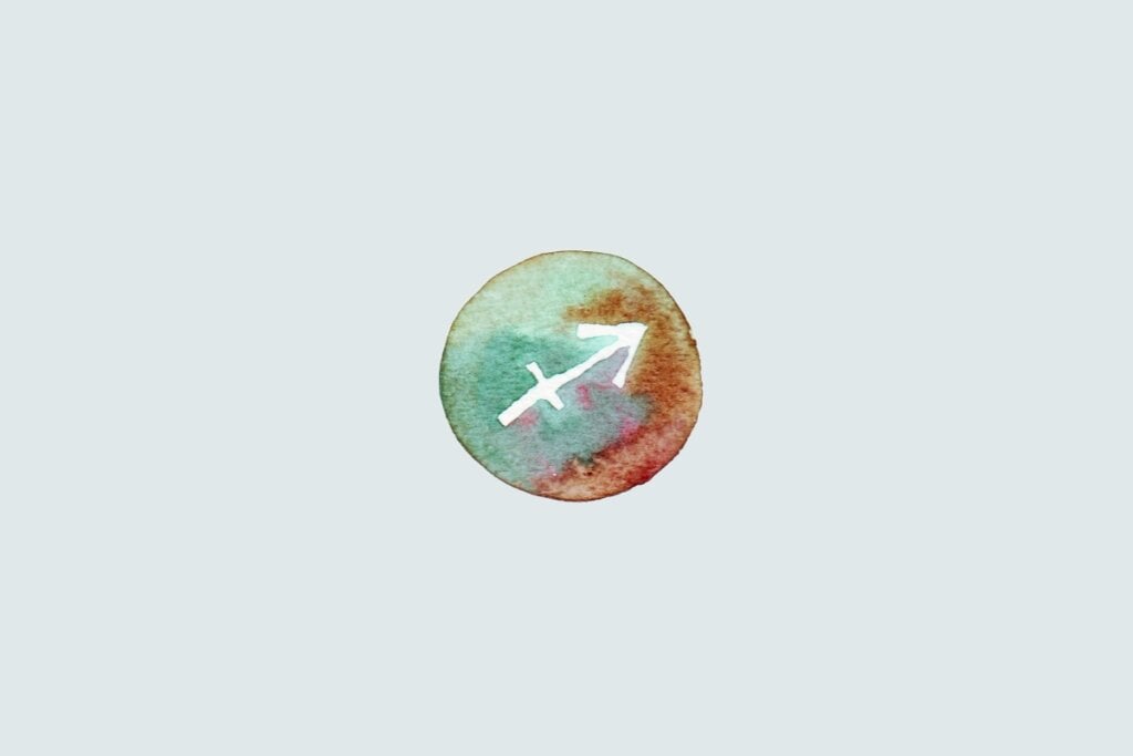 Veja as previsões do baralho cigano de junho para os 12 signos 68 Símbolo do signo de Sagitário com uma flecha inclinada para cima e à direita, sobre fundo colorido em estilo aquarela